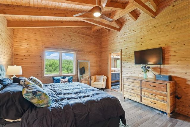 a bedroom with a bed and flat screen tv