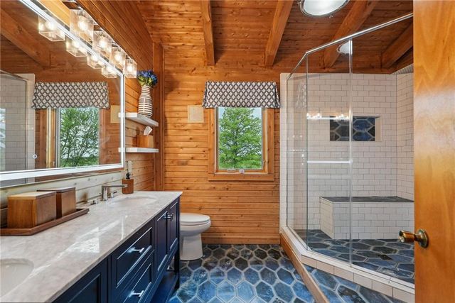 a bathroom with a sink a toilet and shower