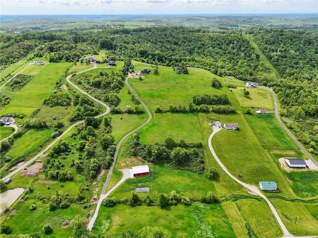 an aerial view of a golf course with parking space