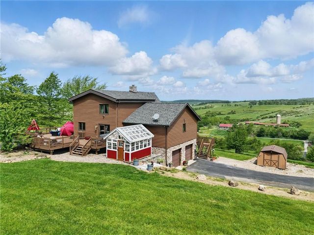 a view of a garden with a table and a chairs