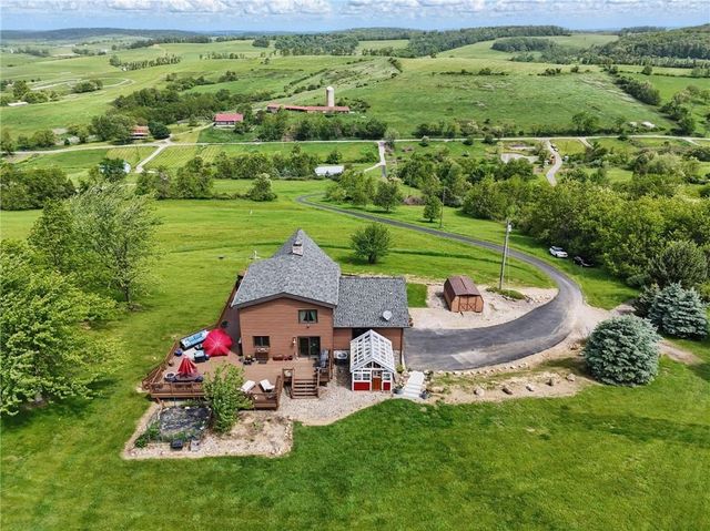 an aerial view of a house with an outdoor space