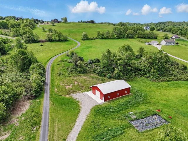 an aerial view of a house with pool big yard and outdoor seating