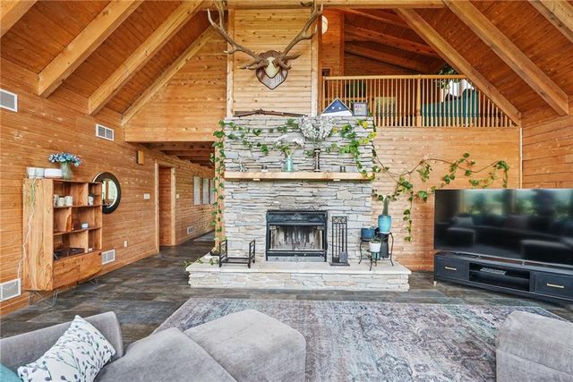 a living room with a flat screen tv and a fireplace