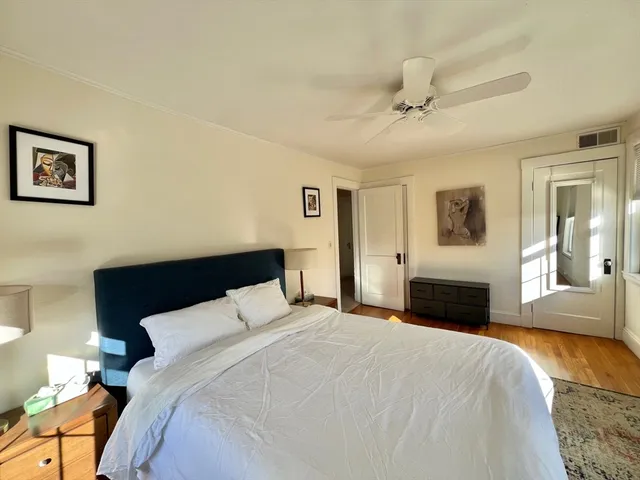 a bedroom with a large bed and a fireplace