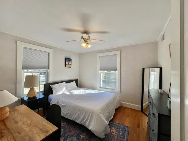 a bedroom with a bed a dresser and a window