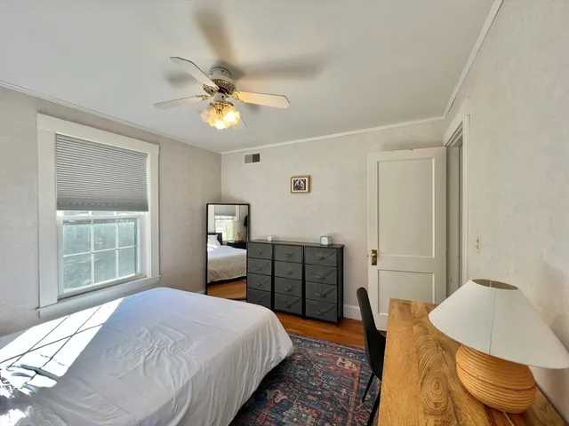 a bedroom with a bed and a chair