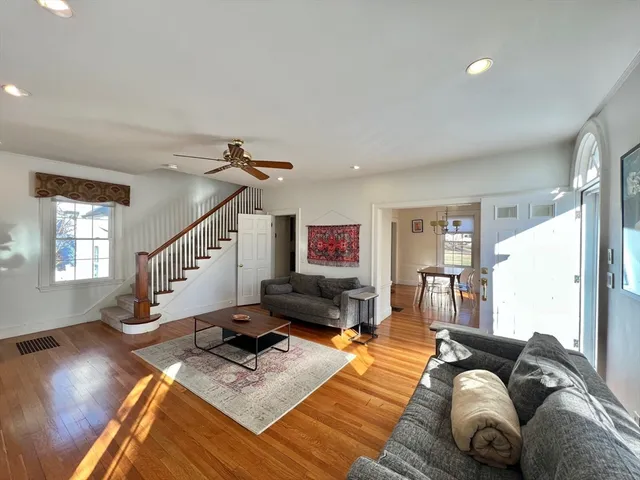 a living room with furniture and a wooden floor