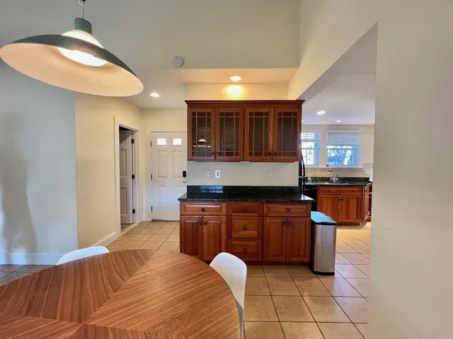 a kitchen with stainless steel appliances granite countertop a sink and a refrigerator