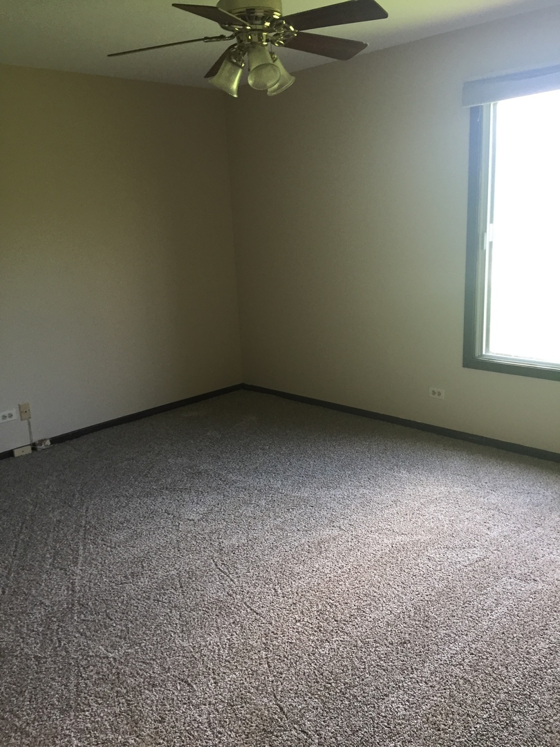 855 Johnstown Lane, Unit B Wheaton, IL 60189 - Photo 6 of 10 a view of an empty room with a window