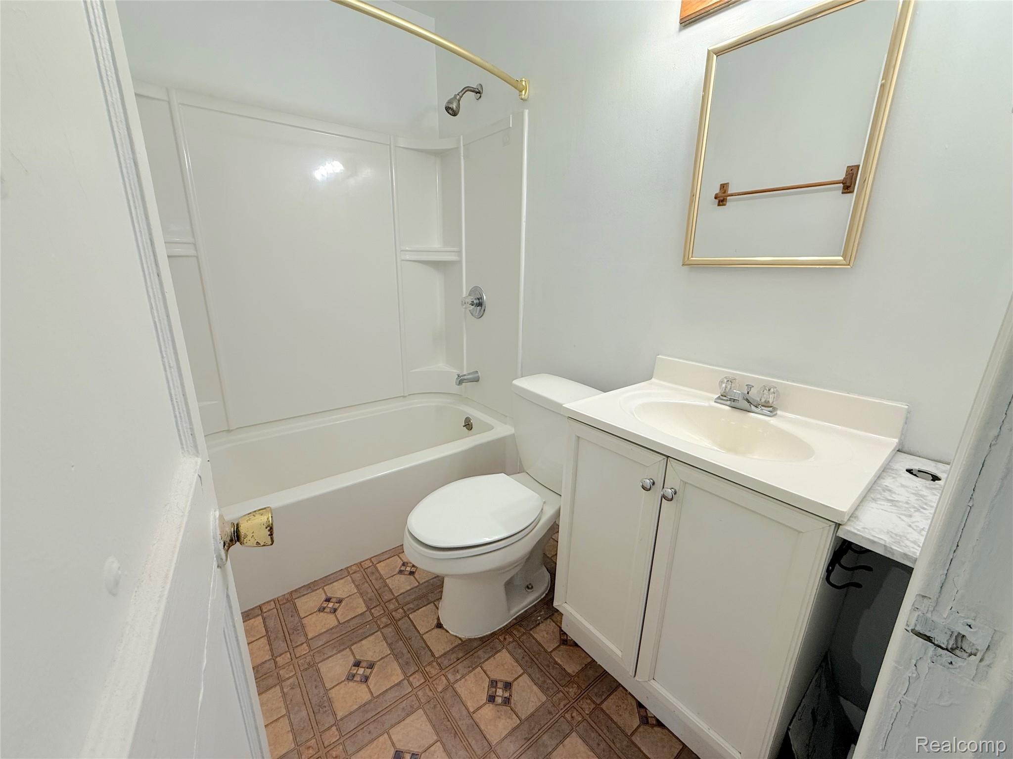 21212 Rensselaer Street Farmington, MI 48336 - Photo 8 of 11 Bathroom featuring a white vanity with integrated sink, chrome faucet, and a large framed mirror
