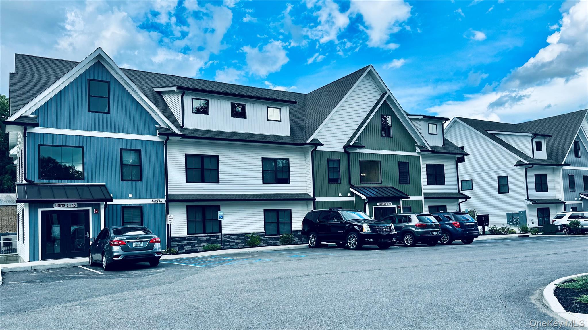 2 South Hills Way, Unit 5 Wappingers Falls, NY 12590 - Photo 1 of 1 a view of a big house with large windows and a car park in front of it