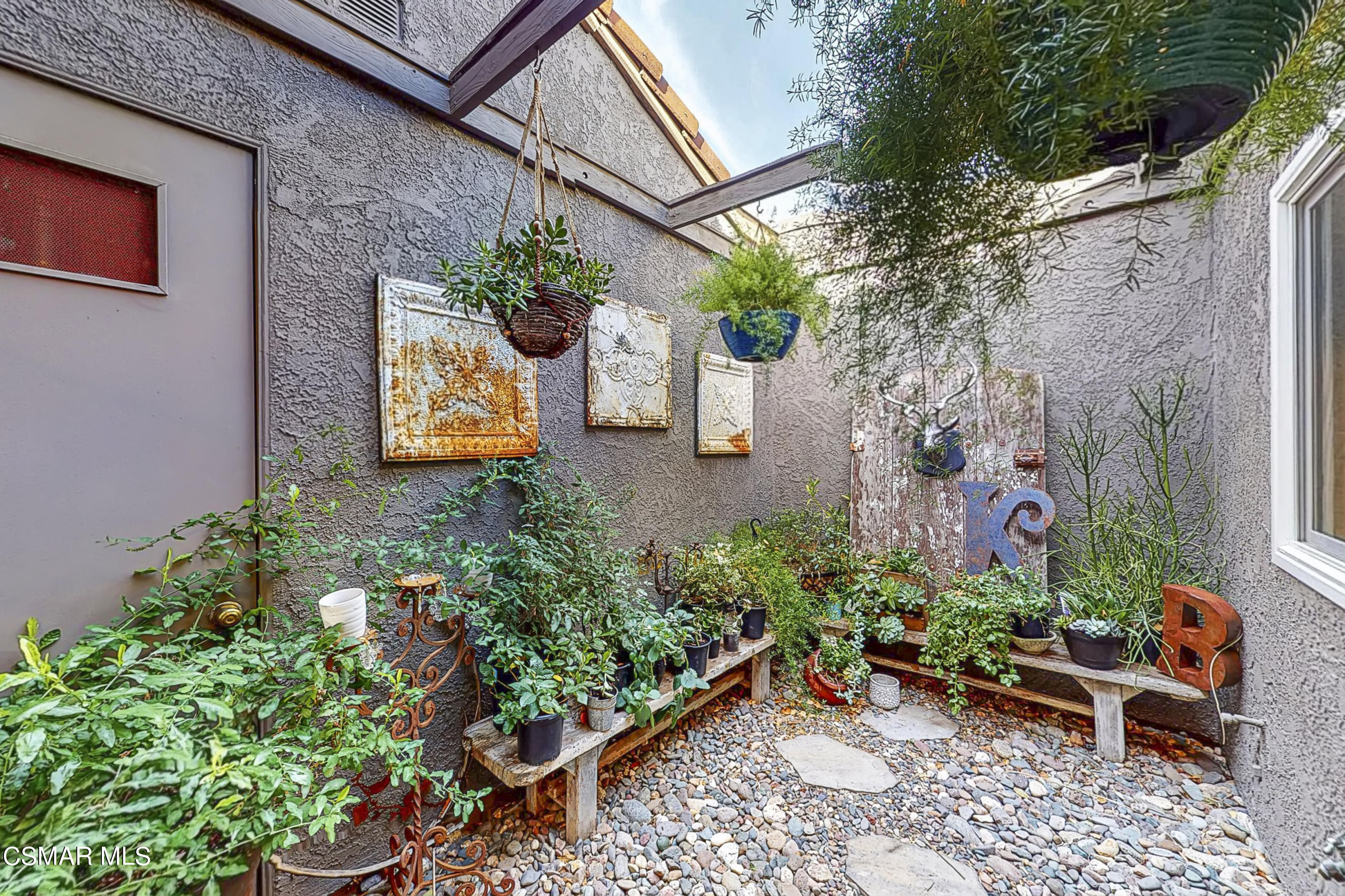 657 Cartpath Place Simi Valley, CA 93065 - Photo 16 of 50 a backyard with plants and outdoor seating