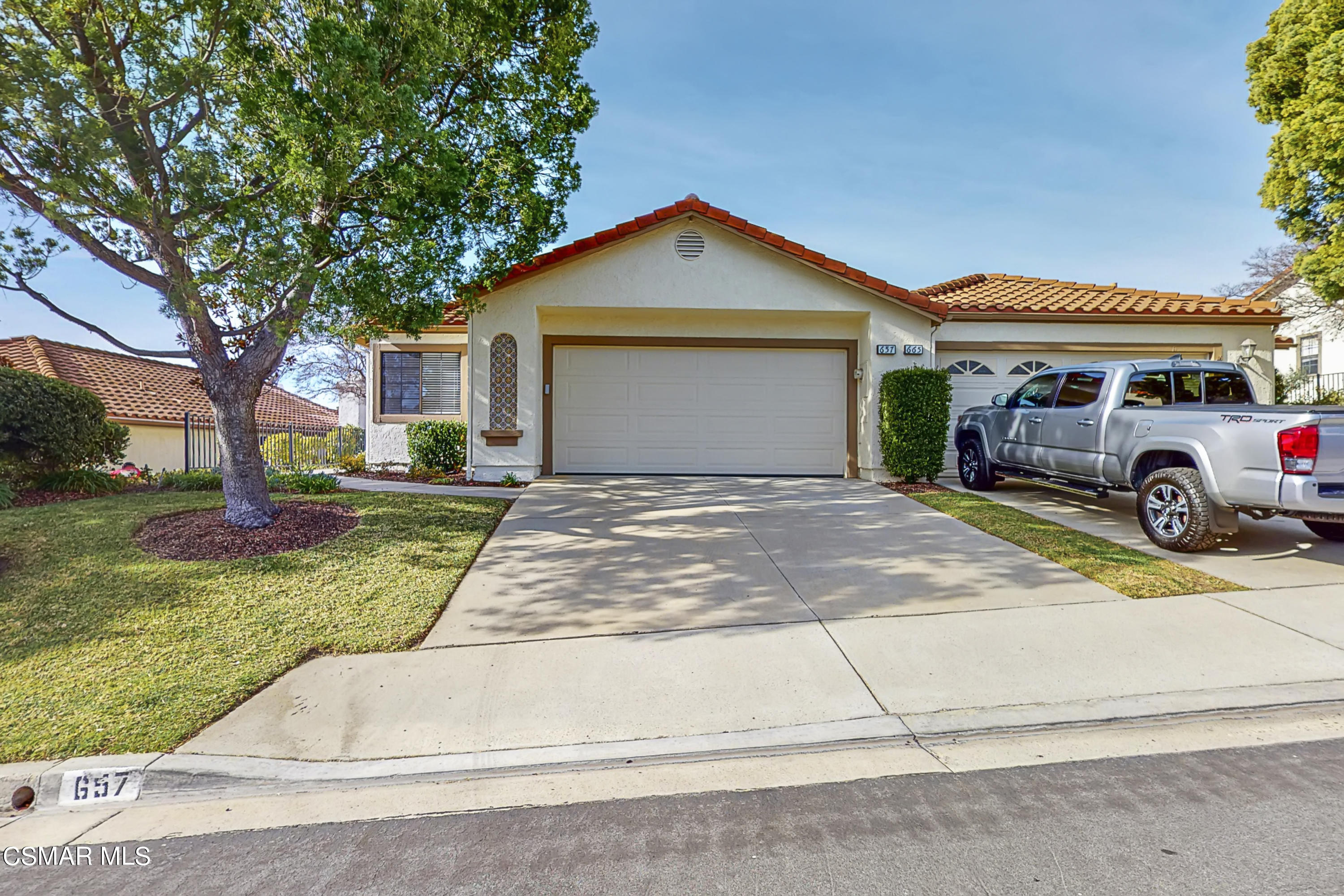 657 Cartpath Place Simi Valley, CA 93065 - Photo 25 of 50 a front view of a house with a yard and garage