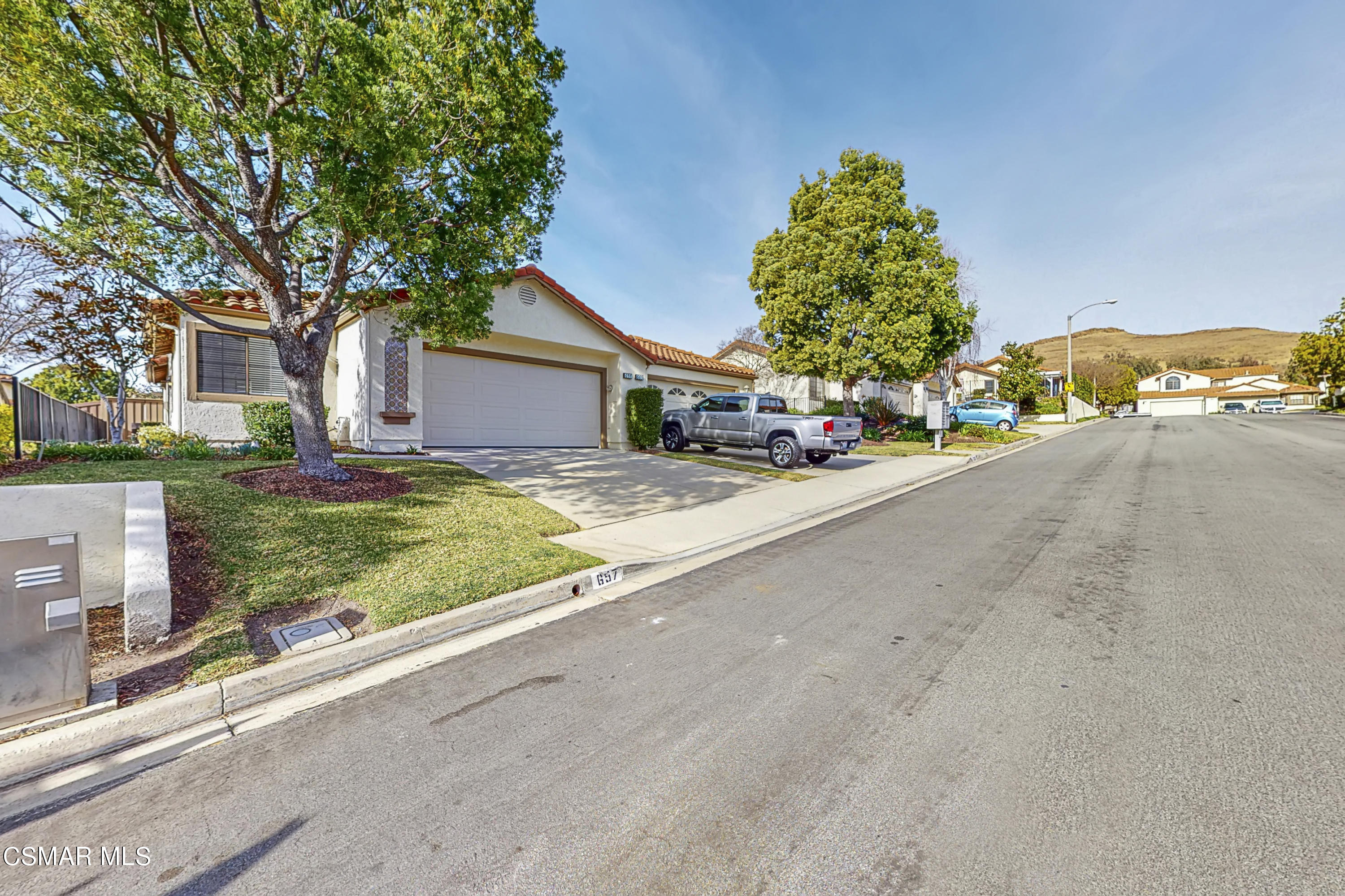 657 Cartpath Place Simi Valley, CA 93065 - Photo 26 of 50 a front view of a house with a yard and garage