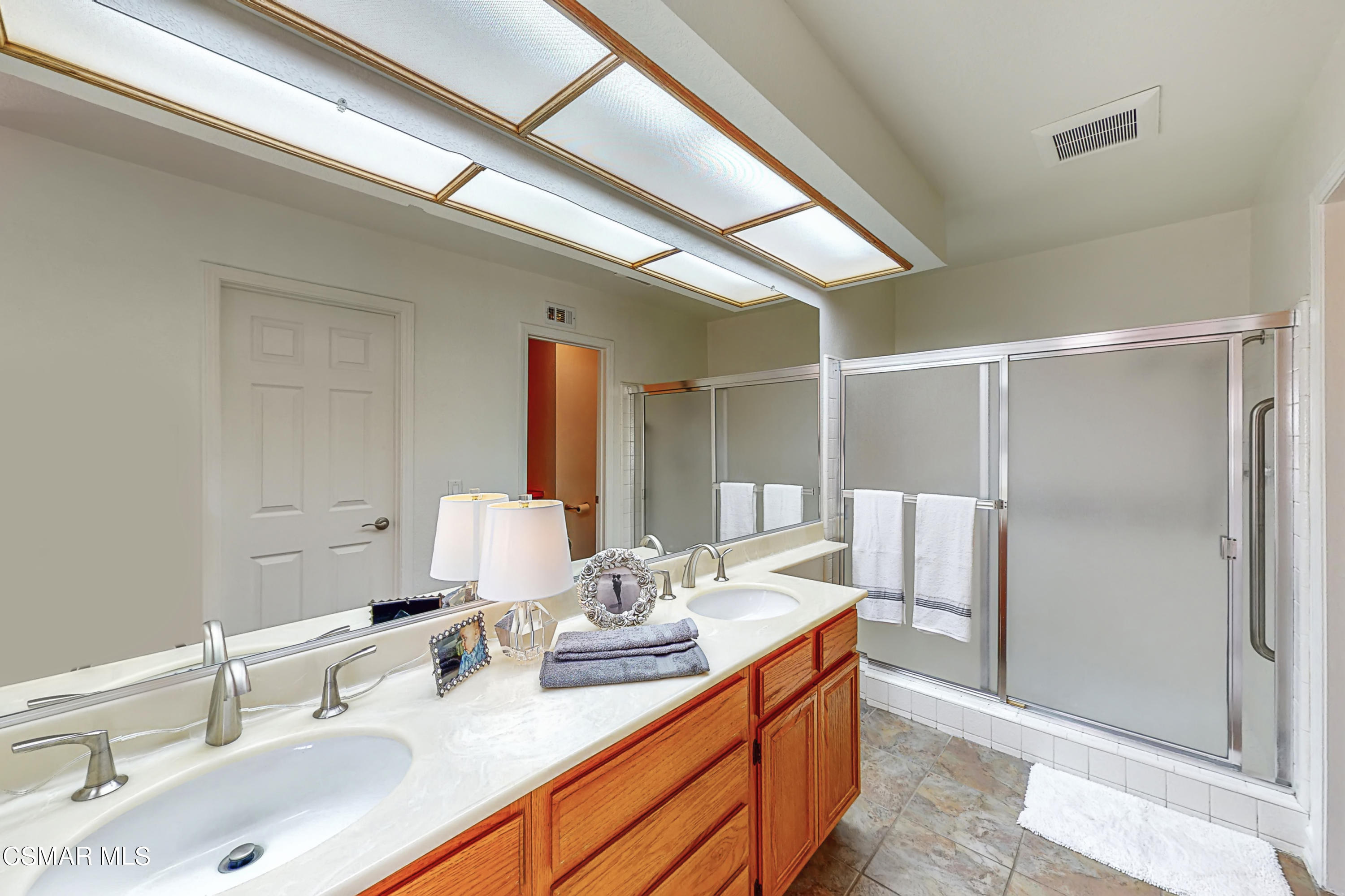 657 Cartpath Place Simi Valley, CA 93065 - Photo 27 of 50 a bathroom with a double vanity sink mirror and shower