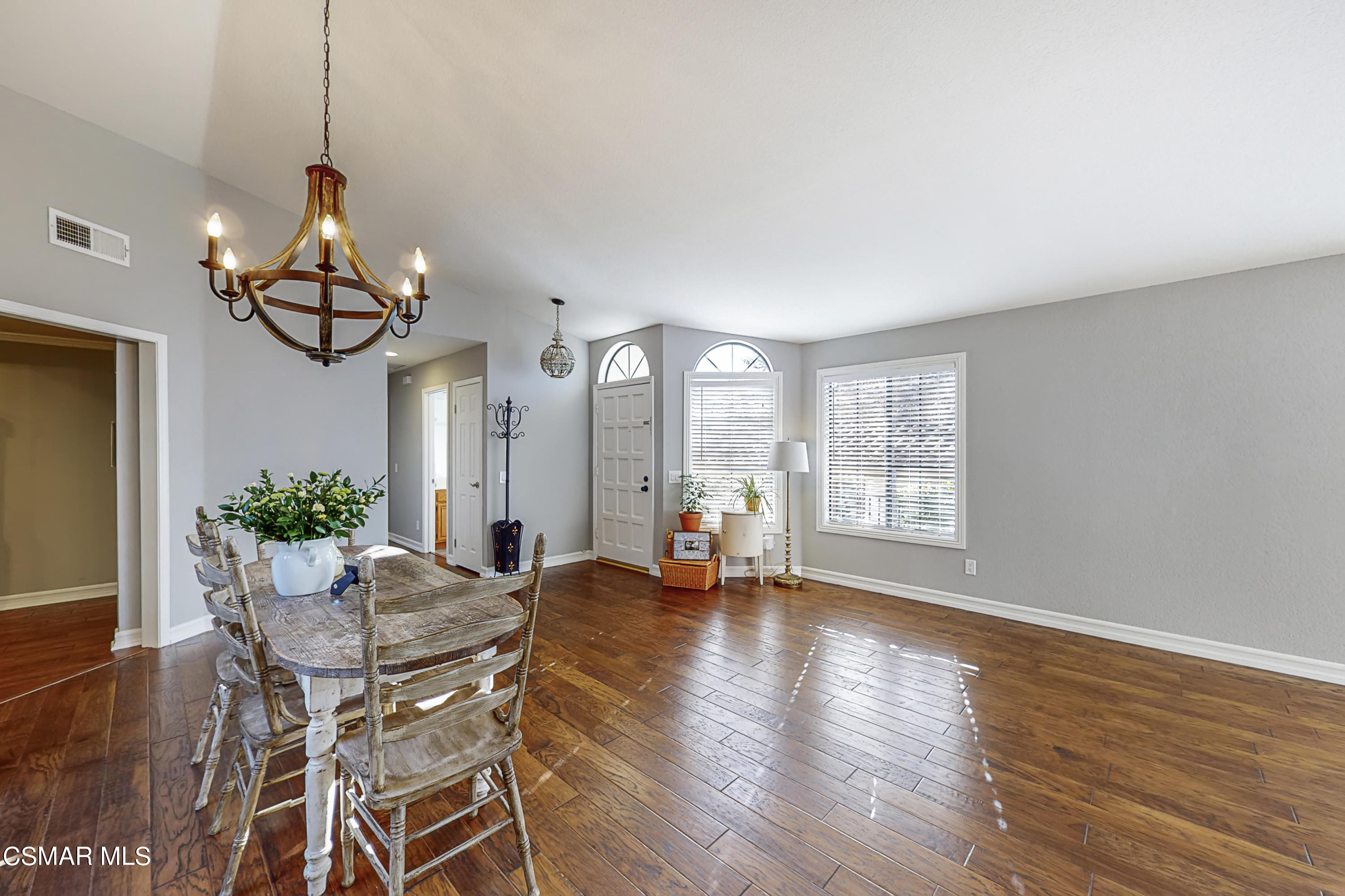 657 Cartpath Place Simi Valley, CA 93065 - Photo 34 of 50 a dining room with wooden floor a chandelier a glass table and chairs