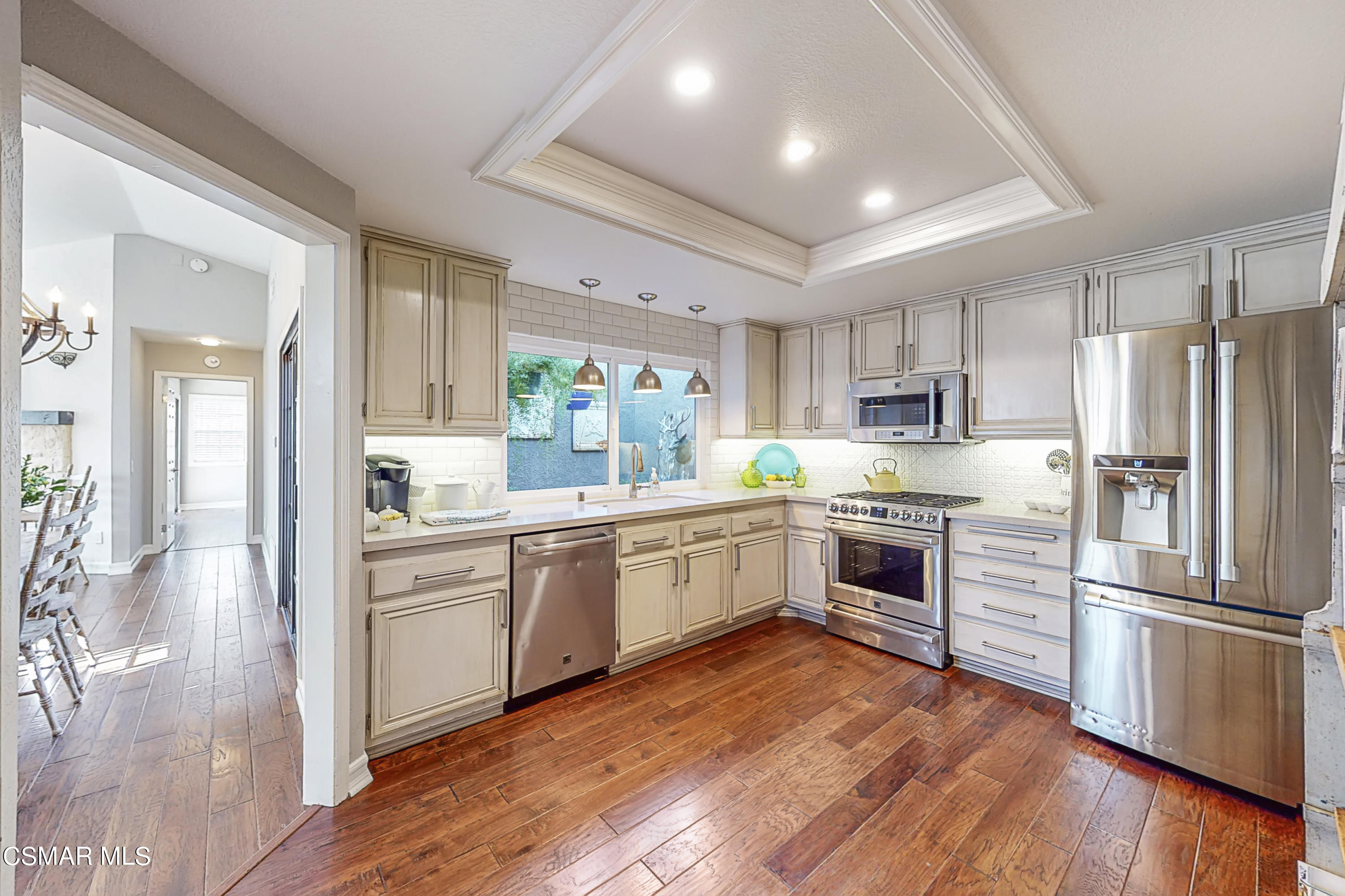657 Cartpath Place Simi Valley, CA 93065 - Photo 36 of 50 a kitchen with a refrigerator stove and white cabinets