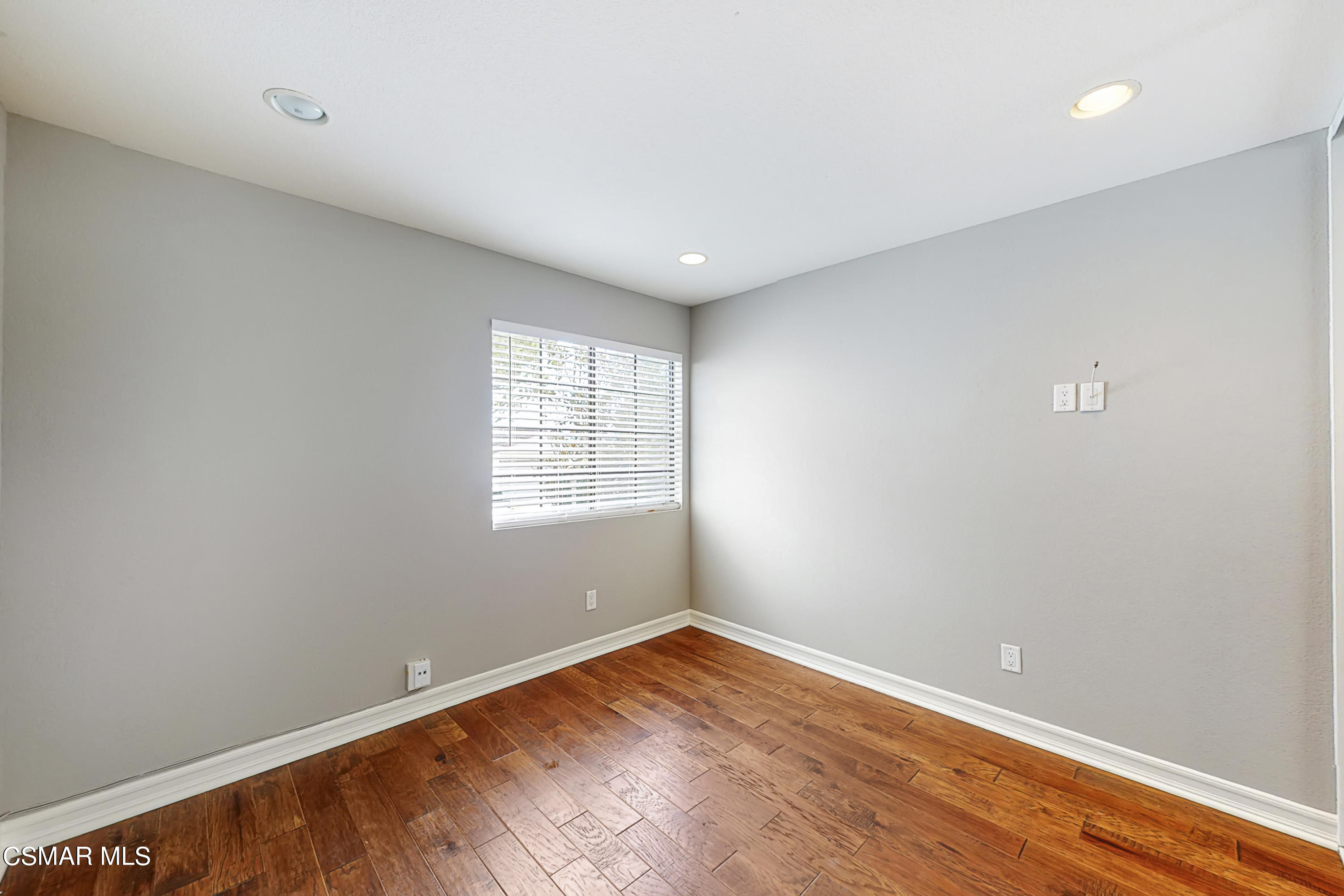 657 Cartpath Place Simi Valley, CA 93065 - Photo 38 of 50 an empty room with wooden floor and windows