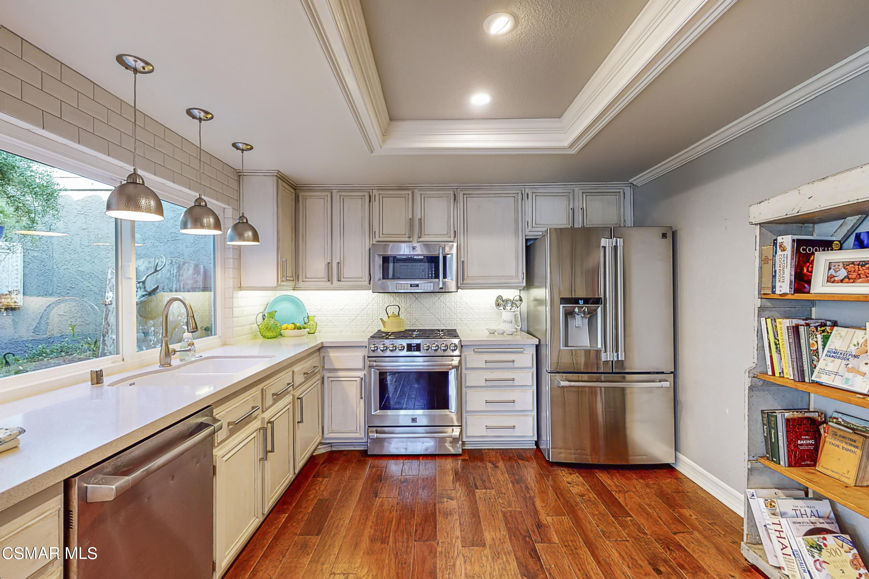657 Cartpath Place Simi Valley, CA 93065 - Photo 6 of 50 a kitchen with stainless steel appliances a stove sink refrigerator cabinets and wooden floor