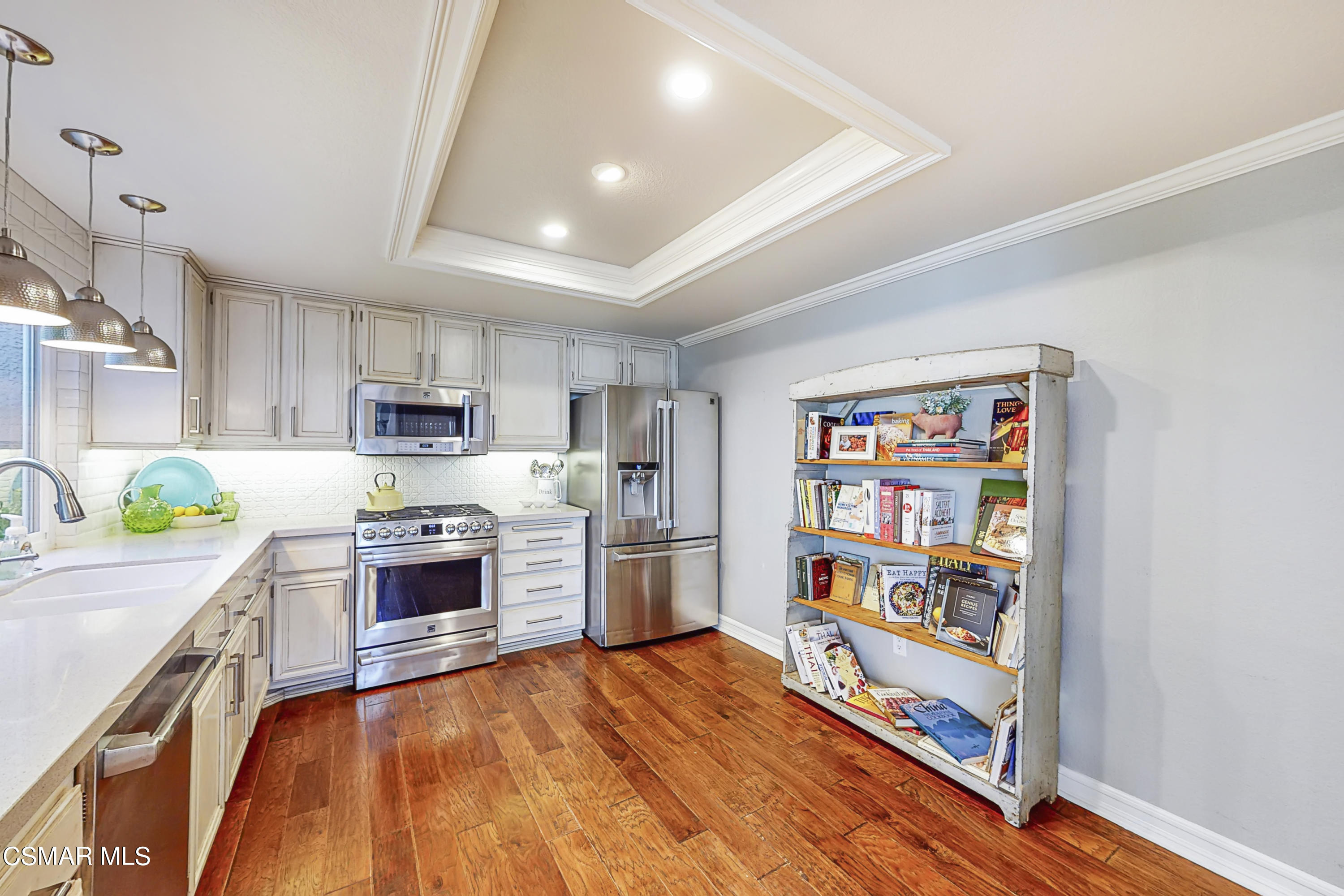 657 Cartpath Place Simi Valley, CA 93065 - Photo 8 of 50 a kitchen with stainless steel appliances a stove top oven a refrigerator a sink and dishwasher with wooden floor