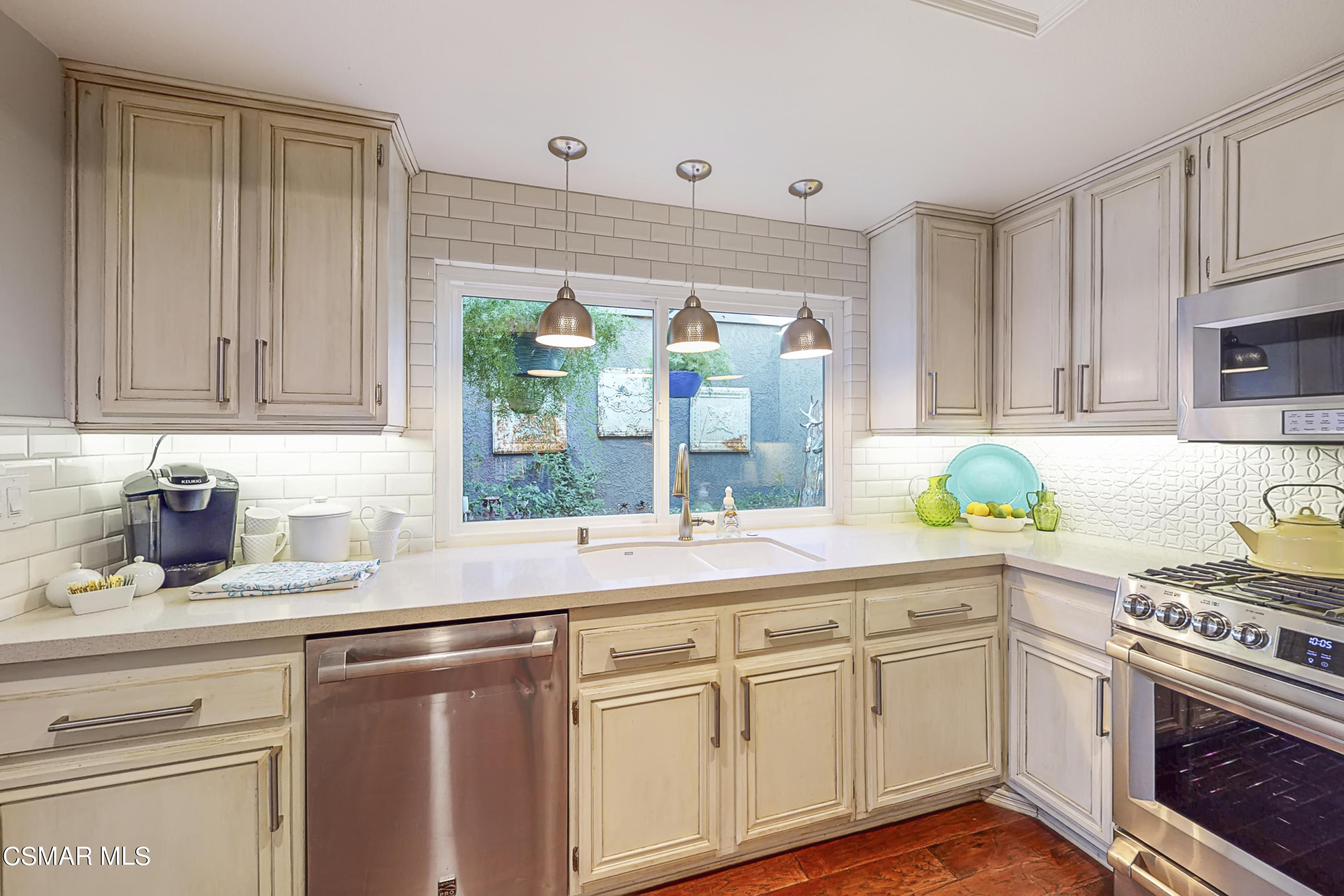 657 Cartpath Place Simi Valley, CA 93065 - Photo 9 of 50 a kitchen with stainless steel appliances granite countertop a sink a stove and cabinets