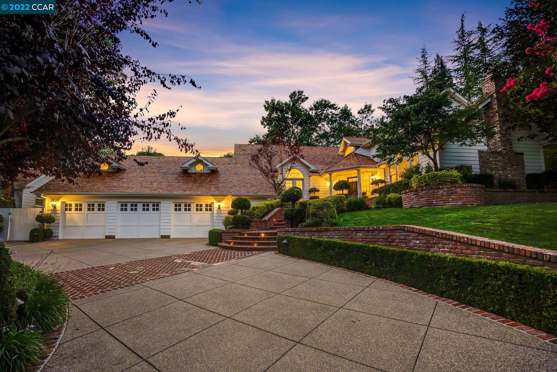 front view of a house with a yard and potted plants