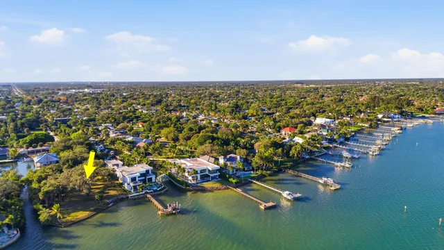 an aerial view of a houses with a lake view