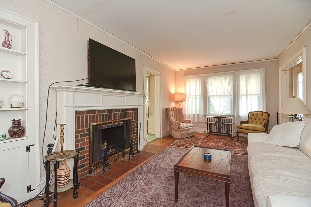 206 Concord Avenue Belmont, MA 02478 - Photo 3 of 18 a living room with furniture a flat screen tv and a fireplace