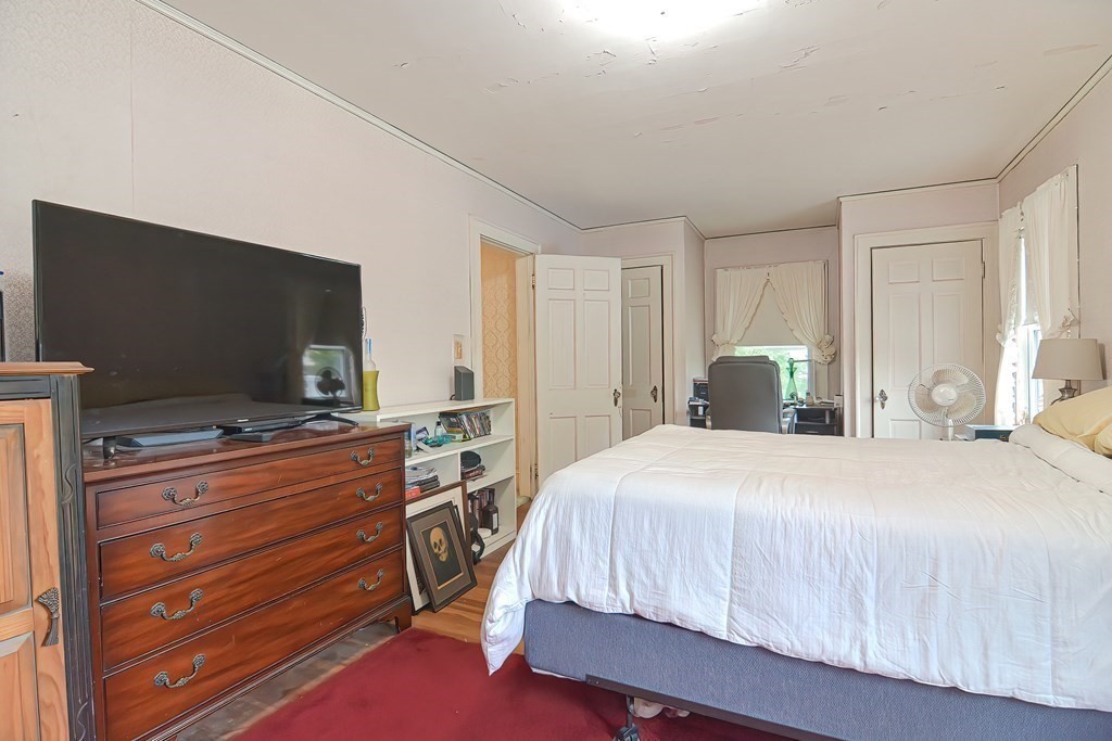 206 Concord Avenue Belmont, MA 02478 - Photo 9 of 18 a bedroom with a bed and a flat screen tv