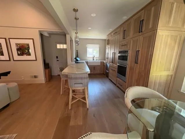 a dining room with furniture a rug and wooden floor