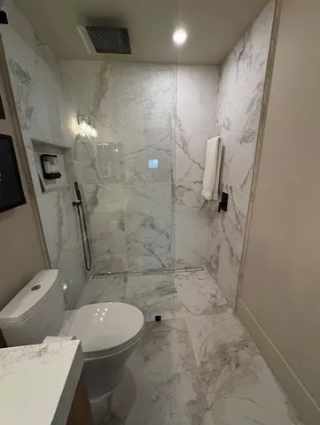 a bathroom with a toilet and shower