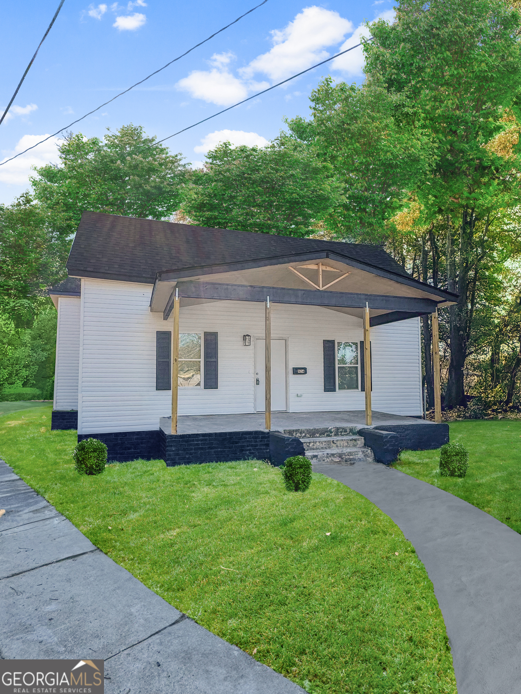 a front view of a house with a garden and yard