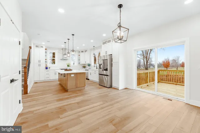 a large kitchen with a large counter top appliances and cabinets