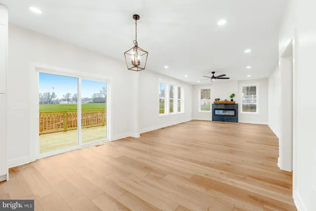 a kitchen with kitchen island a sink stove and wooden floor