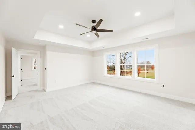 a spacious bathroom with a tub sink toilet and mirror