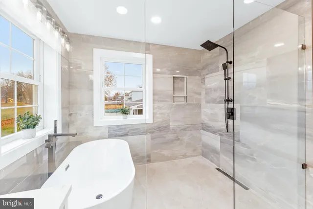 a bathroom with a bathtub and a shower