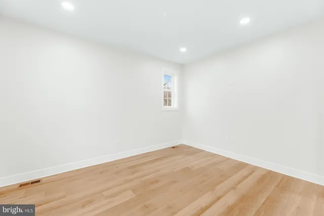 an empty room with windows and entrance