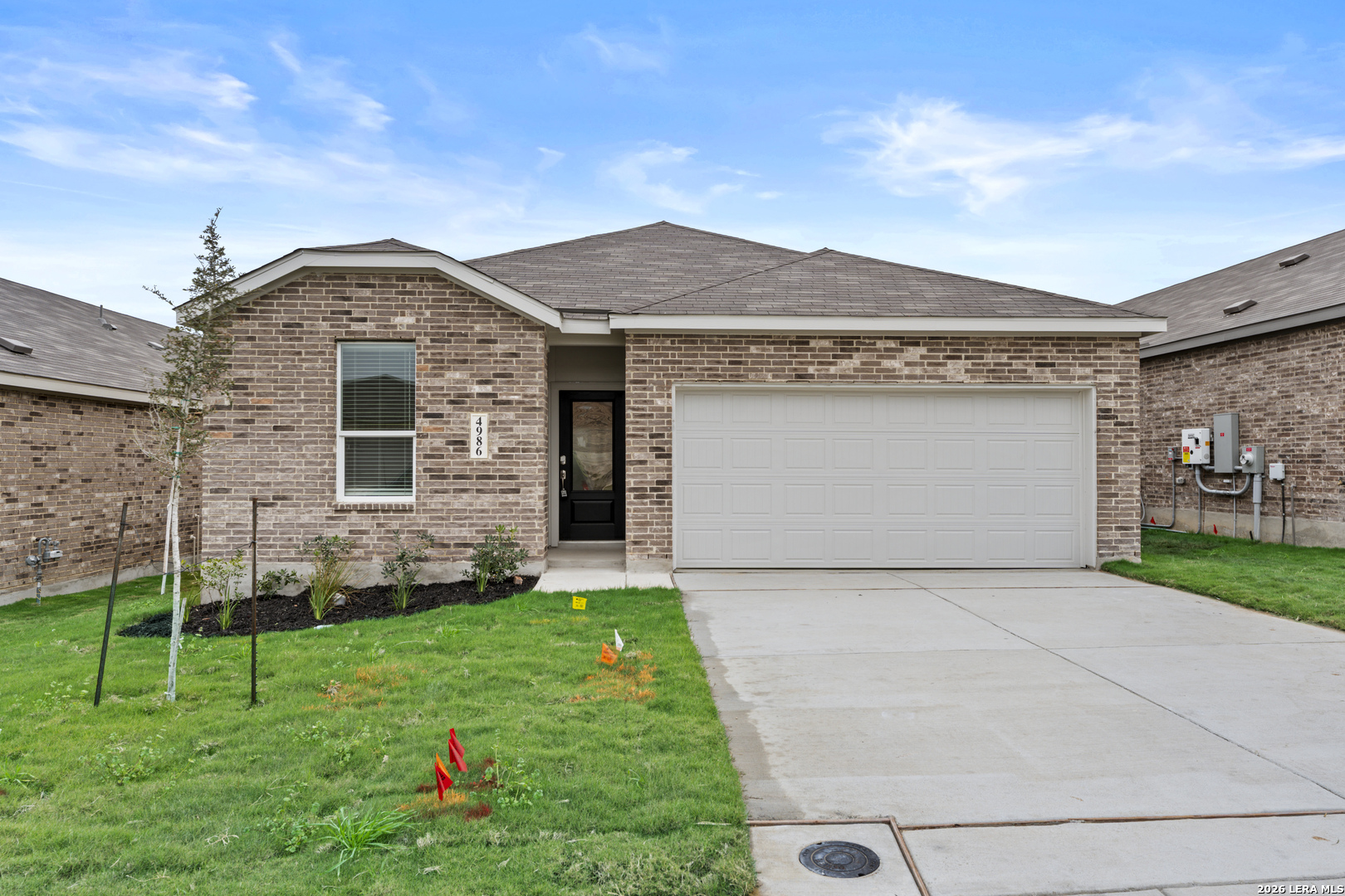 a front view of a house with a yard and a garage
