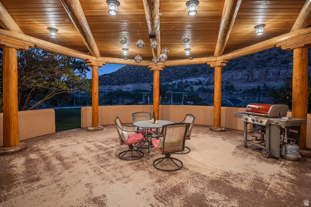 1035 Montezuma Creek Road Monticello, UT 84535 - Photo 13 of 27 Covered outdoor patio featuring a wood-plank ceiling with exposed log beams