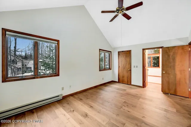 wooden floor in an empty room with a window