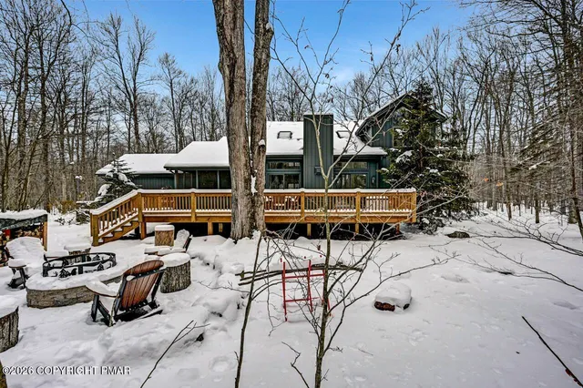 a front view of a house with patio swimming pool and outdoor seating