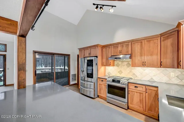 a kitchen with granite countertop stainless steel appliances and counter space