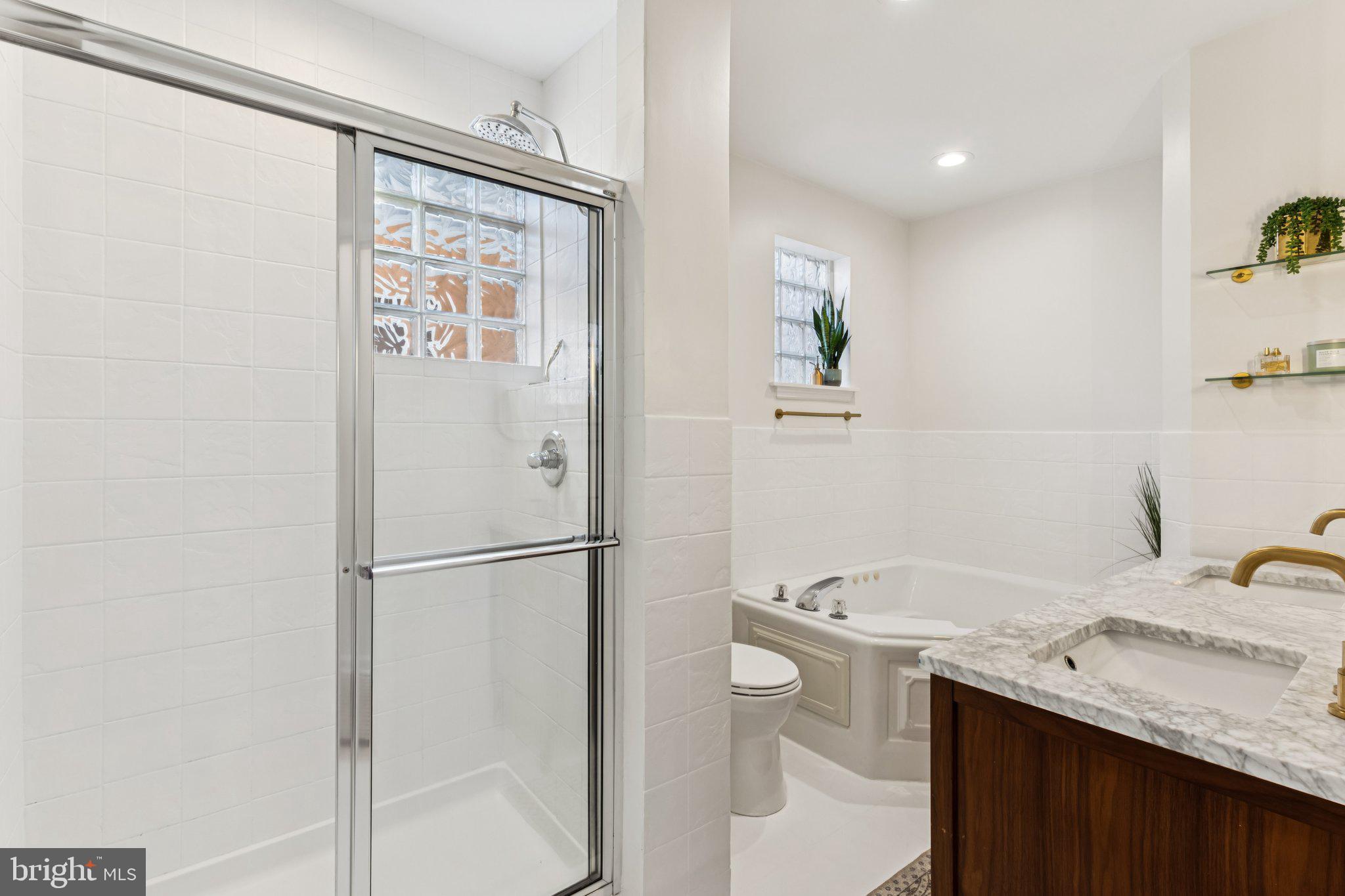 3005 Poplar Street Philadelphia, PA 19130 - Photo 23 of 53 a bathroom with a granite countertop sink a mirror and a shower