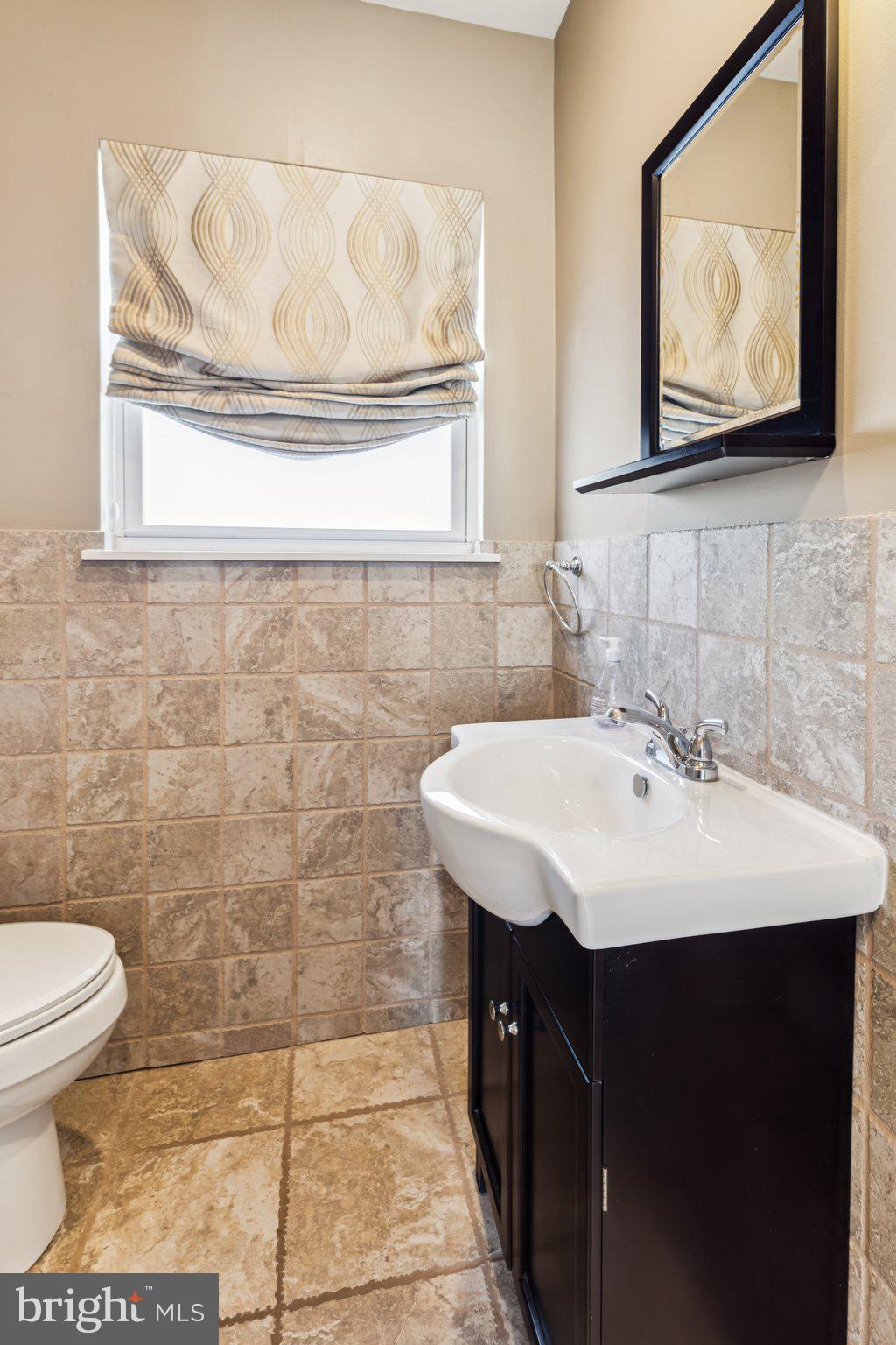 3005 Poplar Street Philadelphia, PA 19130 - Photo 37 of 53 a bathroom with a sink a mirror and a toilet