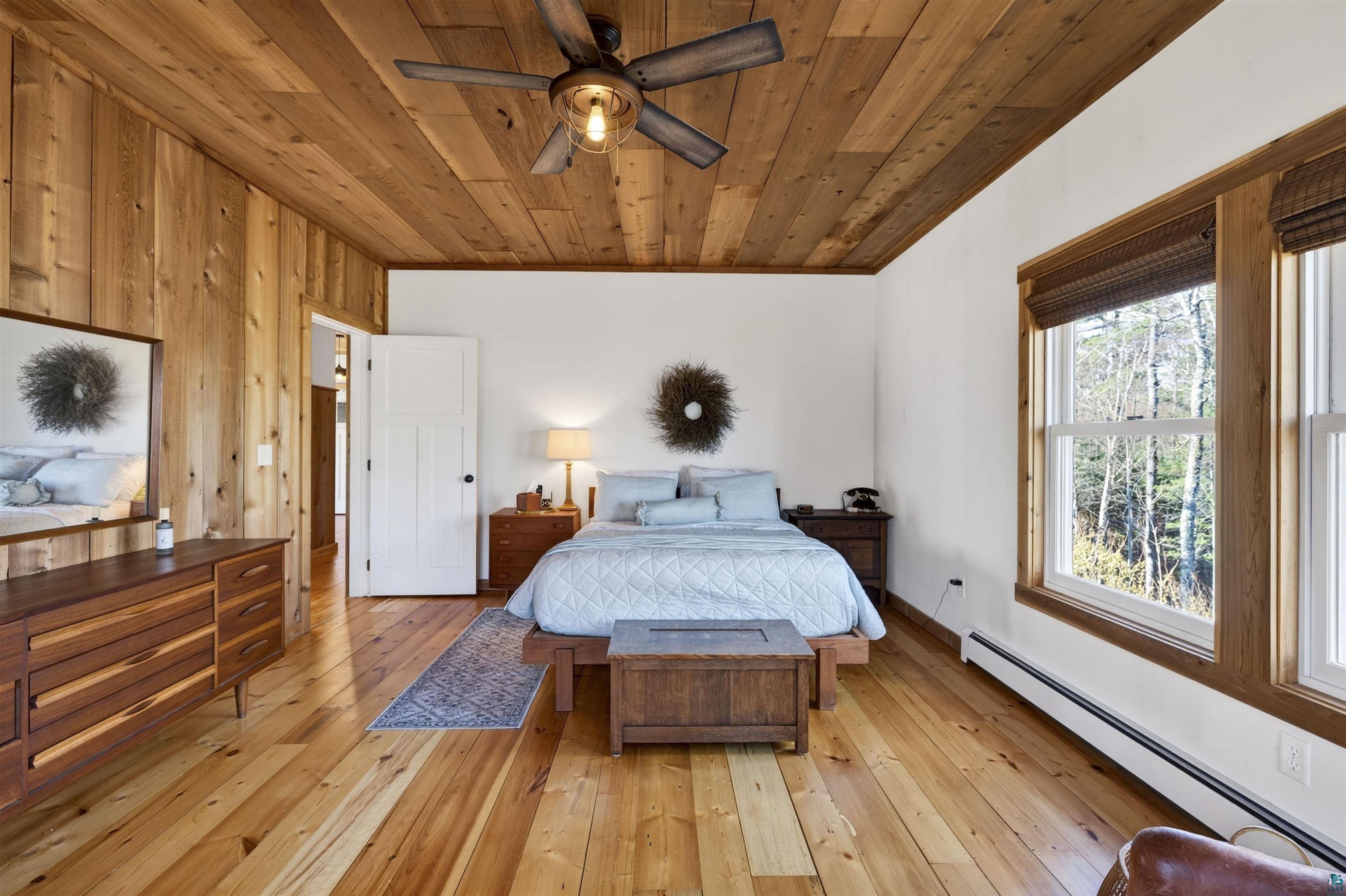 13885 Park Road Brule, WI 54820 - Photo 17 of 41 Wood-paneled wall and ceiling with a wooden ceiling fan