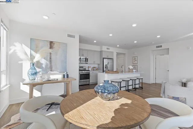 a living room with furniture and kitchen view