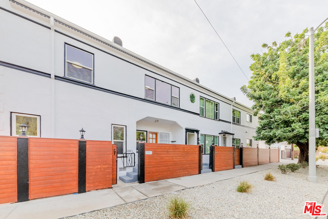 1251 South Muirfield Road Los Angeles, CA 90019 - Photo 17 of 24 a front view of a house with a yard