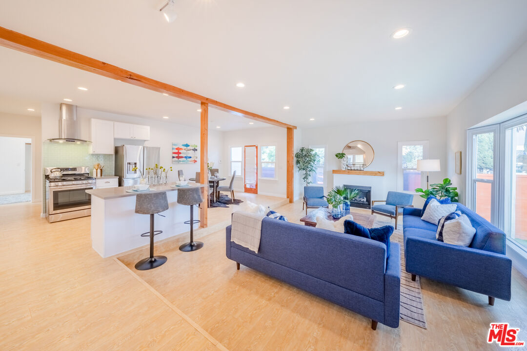 1251 South Muirfield Road Los Angeles, CA 90019 - Photo 2 of 24 a living room with furniture and a large window
