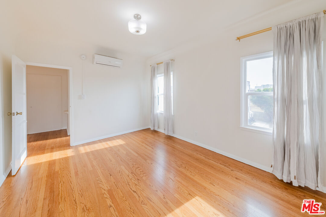 1251 South Muirfield Road Los Angeles, CA 90019 - Photo 22 of 24 a view of empty room with wooden floor and fan