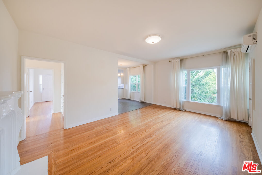 1251 South Muirfield Road Los Angeles, CA 90019 - Photo 24 of 24 a view of empty room with wooden floor and fan